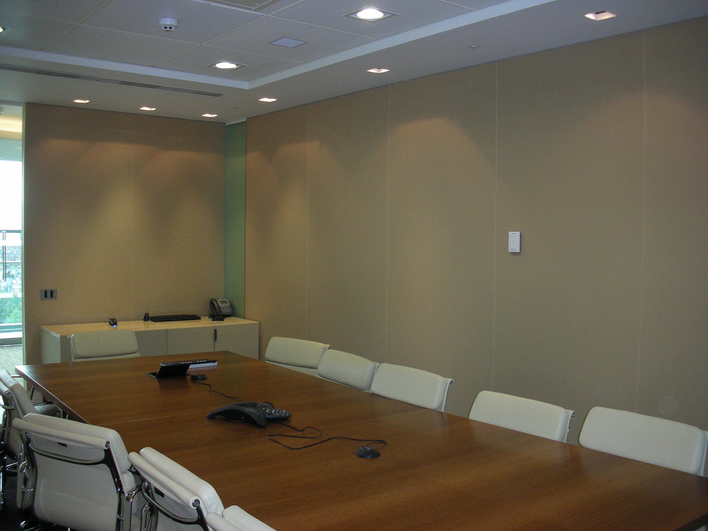 Full-height stretch fabric acoustic wall panels in a corporate conference room