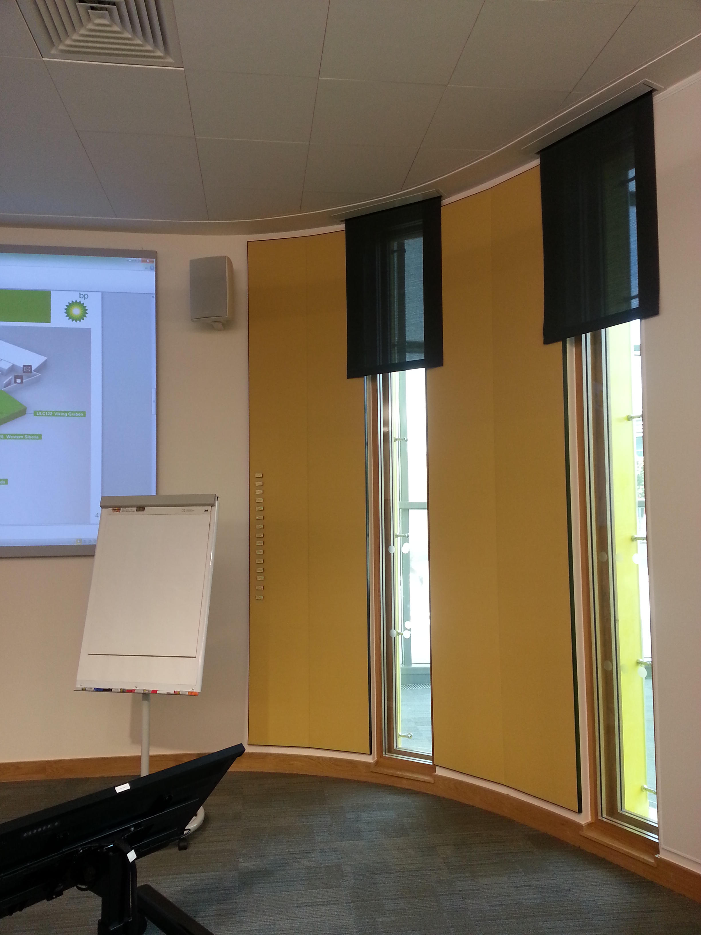 Magnetic acoustic wall panels installed in a meeting and presentation room