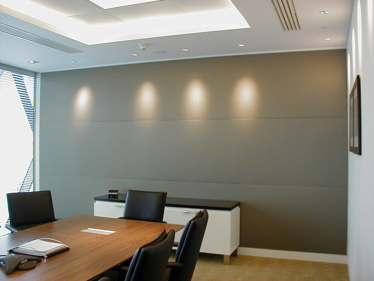 Stretch fabric acoustic wall panels installed in a commercial meeting room