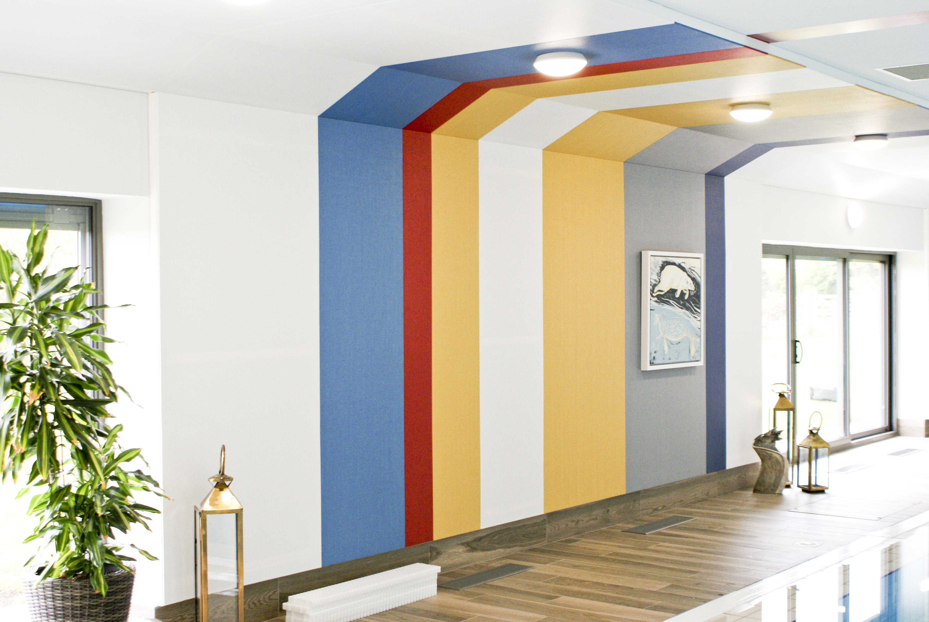 Colorful striped wall design with plants and decorative lanterns