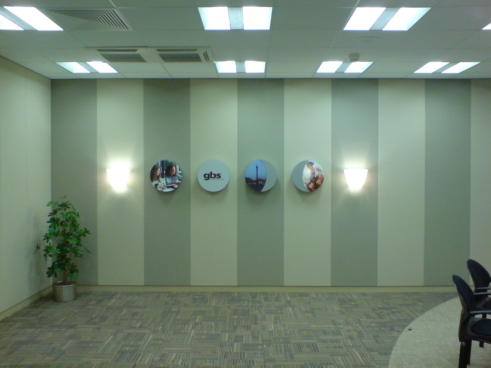 Stretch fabric acoustic wall system with alternating panel sections in a commercial interior